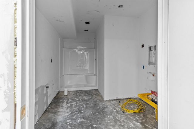Bathroom with a shower and unfinished concrete floors | Image 49