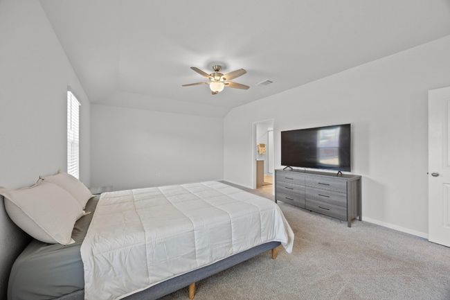 Primary bedroom with light colored carpet and a ceiling fan | Image 18