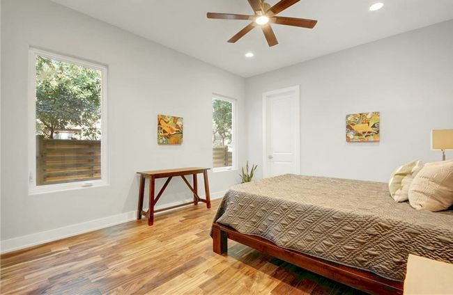 Bedroom featuring light wood-style floors, multiple windows, and recessed lighting | Image 13