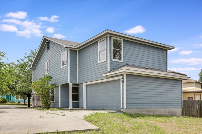 View of property exterior featuring driveway and an attached garage | Image 36