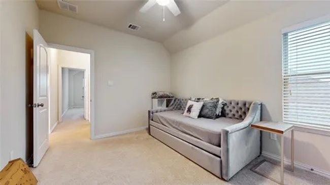Bedroom with ceiling fan, light carpet, and lofted ceiling | Image 13