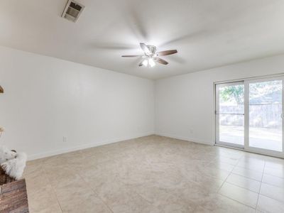 Spare room with ceiling fan and light tile patterned floors | Image 3