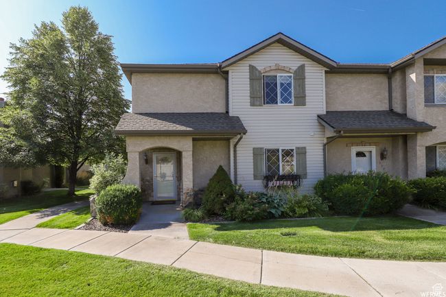 View of front facade with stucco siding, a front yard, and a shingled roof | Image 45