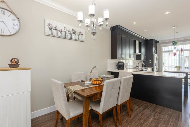 Dining area featuring ornamental molding, a chandelier, dark wood finished floors, baseboards, and recessed lighting | Image 15