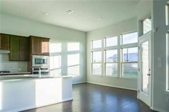 Kitchen featuring stainless steel microwave, healthy amount of natural light, decorative backsplash, and light countertops | Image 11