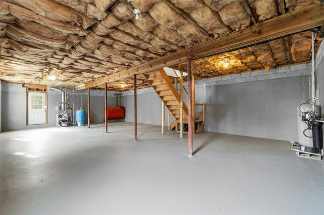 Below grade area featuring stairs, a heating unit, and heating fuel | Image 30