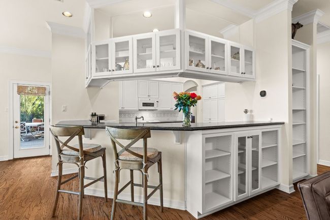 Kitchen with tons of cabinets and built-ins, and a breakfast bar. | Image 13