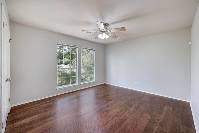 Unfurnished room featuring ceiling fan, dark wood-type flooring, and baseboards | Image 26