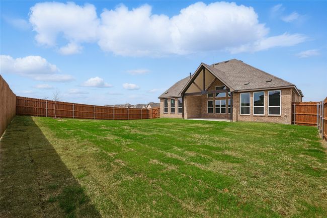 Back of house featuring a lawn, a shingled roof, a fenced backyard, and a patio | Image 28