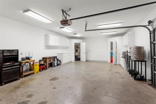 Right side of the garage used as a workshop. Has a single roll up garage door with automatic opener, built in cabinets and two walk in storage closets. | Image 34