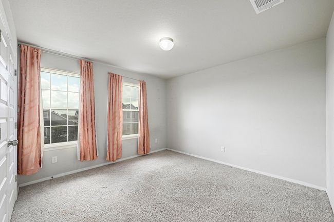 Great sized secondary bedroom upstairs with two large windows. | Image 21