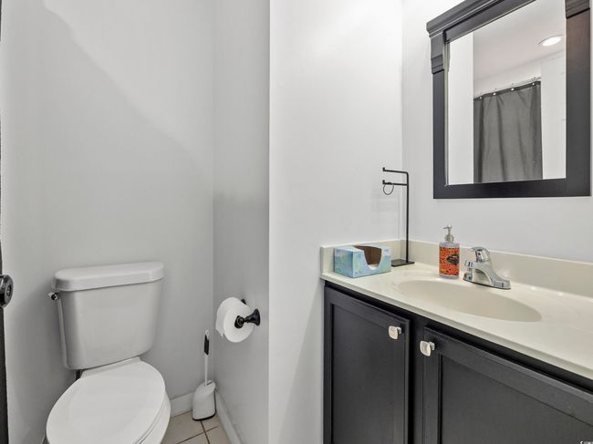 Full bathroom with vanity, tile patterned flooring, baseboards, and toilet | Image 23