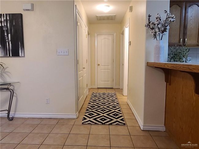 Corridor featuring light tile patterned floors and baseboards | Image 5
