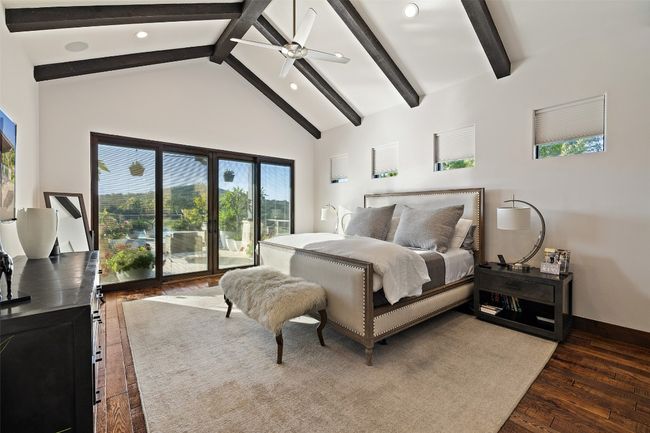 Bedroom with beamed ceiling, hardwood / wood-style flooring, access to outside, high vaulted ceiling, and recessed lighting | Image 6