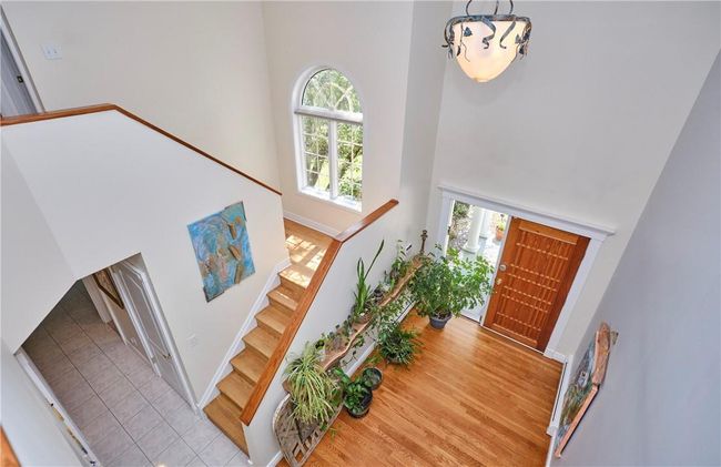 Foyer featuring a towering ceiling and light hardwood / wood-style flooring | Image 11