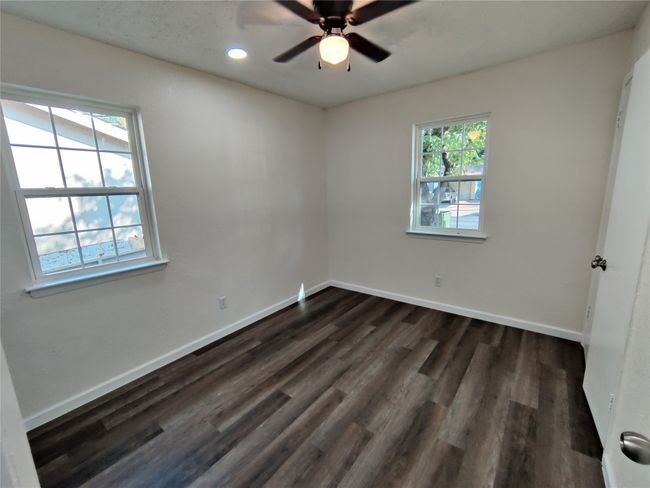 Empty room with ceiling fan and wood-type flooring | Image 10