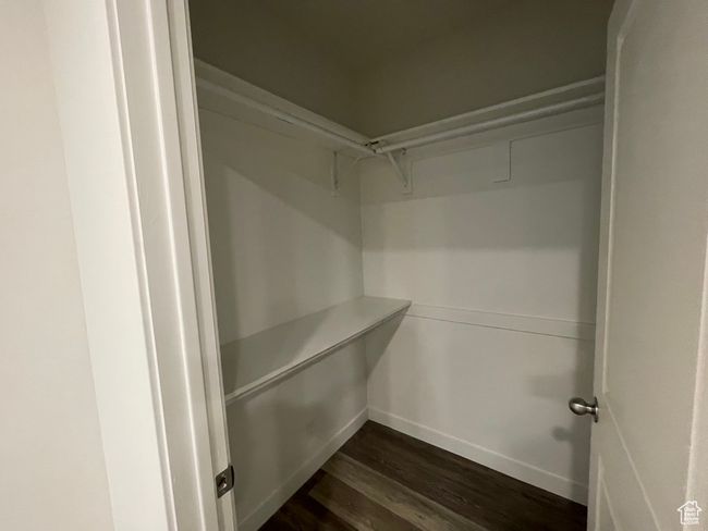 Spacious closet with dark hardwood / wood-style floors | Image 23