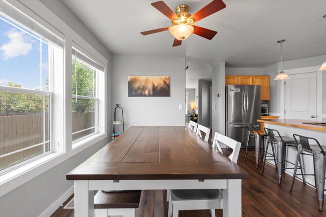 Dining area with large picture window, and ceiling fan | Image 13