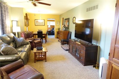 Spacious Living Room with Brick Fireplace and Picture Window | Image 3