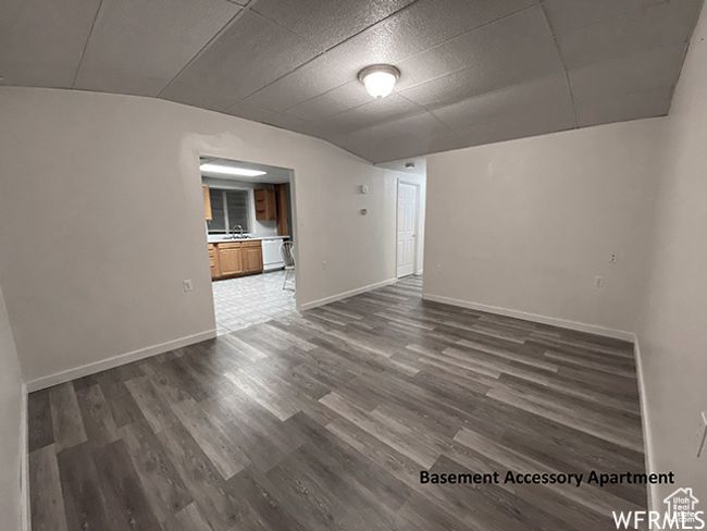 Spare room featuring dark wood finished floors, baseboards, and a sink | Image 18