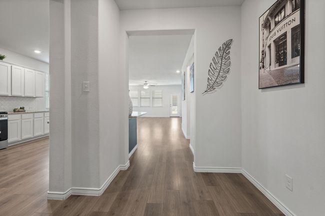 Hallway with dark wood-style flooring, recessed lighting, and baseboards | Image 8