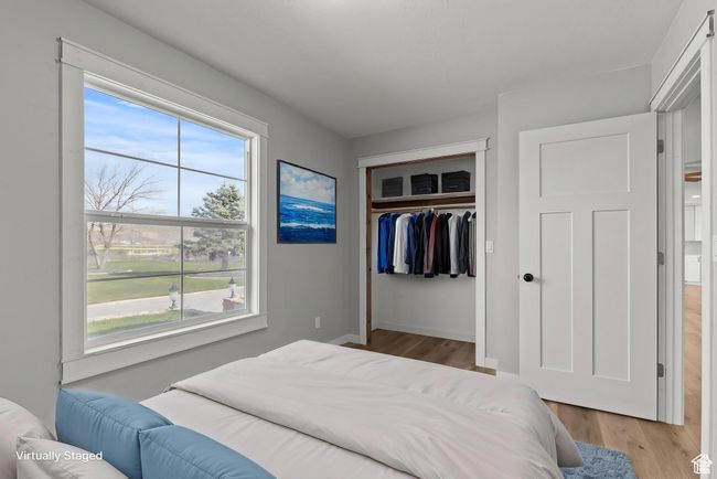 Bedroom featuring wood finished floors and a closet | Image 9