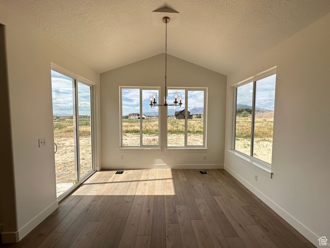 Unfurnished sunroom with a chandelier and lofted ceiling | Image 10