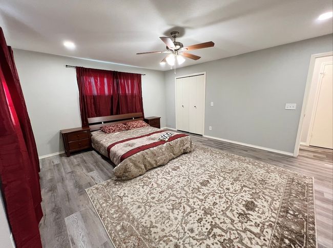 Bedroom with wood finished floors, a ceiling fan, recessed lighting, and a closet | Image 7
