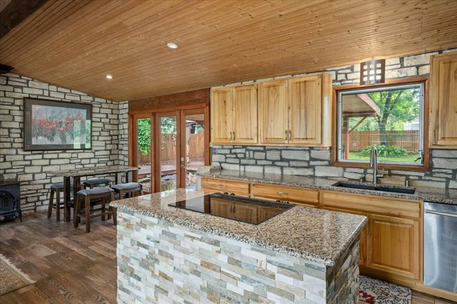 Kitchen featuring stovetop, stainless steel dishwasher, wood ceiling, french doors, and dark wood finished floors | Image 10