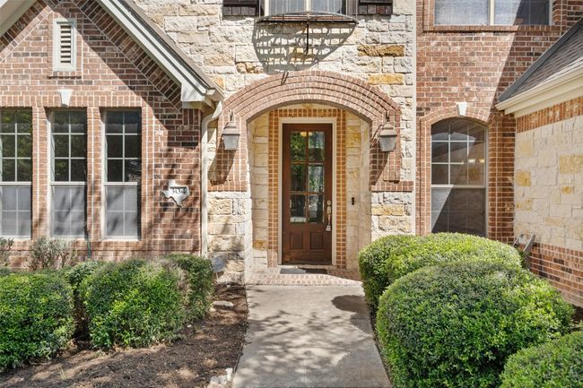 A striking blend of brick and stone gives the front elevation of this home a classic yet distinctive character. | Image 5
