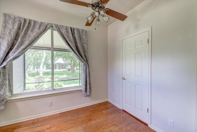 Primary room bonus space featuring a ceiling fan and wood finished floors | Image 16