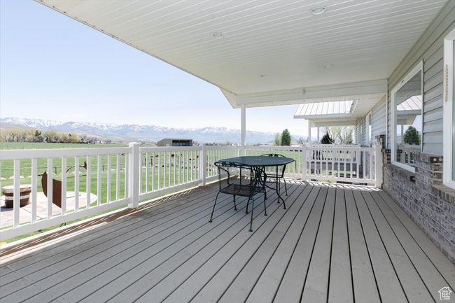 Wooden deck with a mountain view and outdoor dining space | Image 60