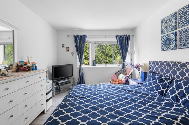 Bedroom with multiple windows and light wood-type flooring | Image 21