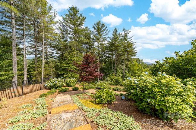 Thoughtful landscaping design is terraced with stairs among the flowering gardens. | Image 37
