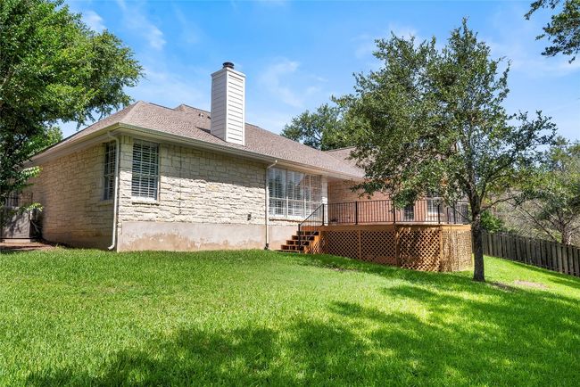 The backyard offers a private, peaceful retreat, with mature trees providing ample shade and a lush, green landscape perfect for outdoor activities | Image 33