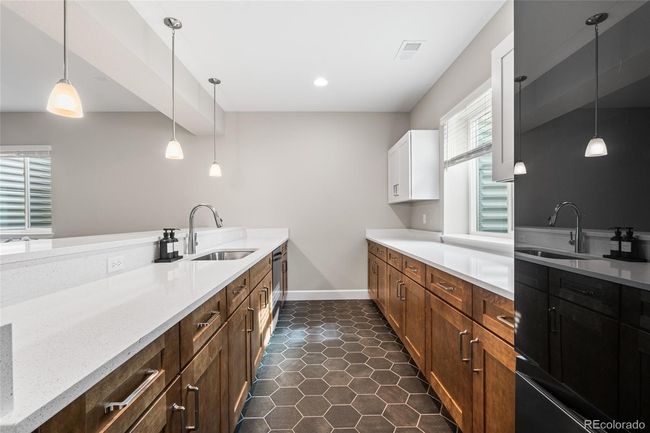 Full-size finished basement with 2nd kitchen area/wetbar complete with Samsung BeSpoke fridge and dishwasher, quartz countertops and plenty of cabinet storage. | Image 36