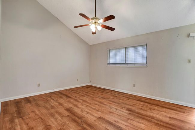 Primary bedroom with an angled ceiling | Image 21