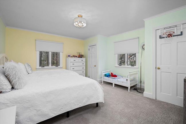 Bedroom with carpet floors, multiple windows, and crown molding | Image 16