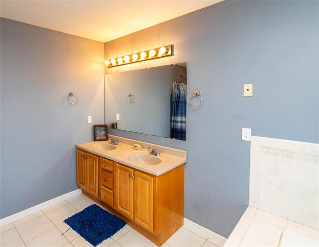 Bathroom featuring a sink, double vanity, and tile patterned flooring | Image 29