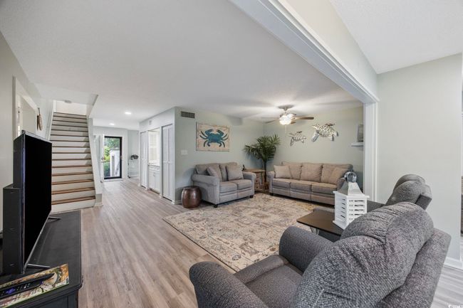 Living area with wood finished floors, stairs, ceiling fan, baseboards, and recessed lighting | Image 16
