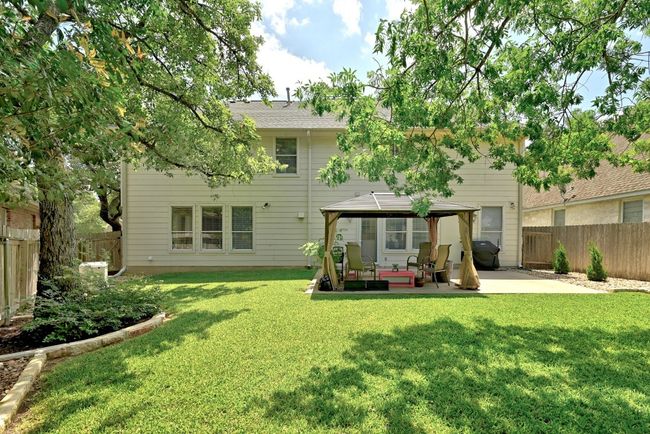 Rear view of house with a gazebo, a patio, and a fenced backyard | Image 31