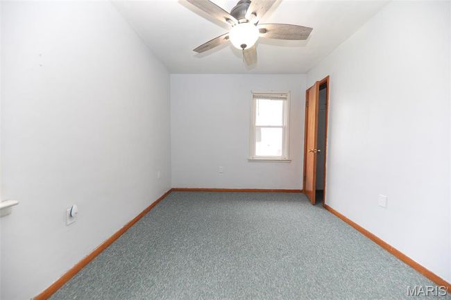 Spare room featuring baseboards, a ceiling fan, and light carpet | Image 13