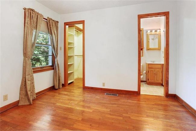 Empty room with light wood-style floors and baseboards | Image 7