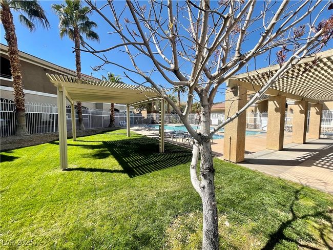 View of yard with a patio area, a fenced backyard, a community pool, and a pergola | Image 51