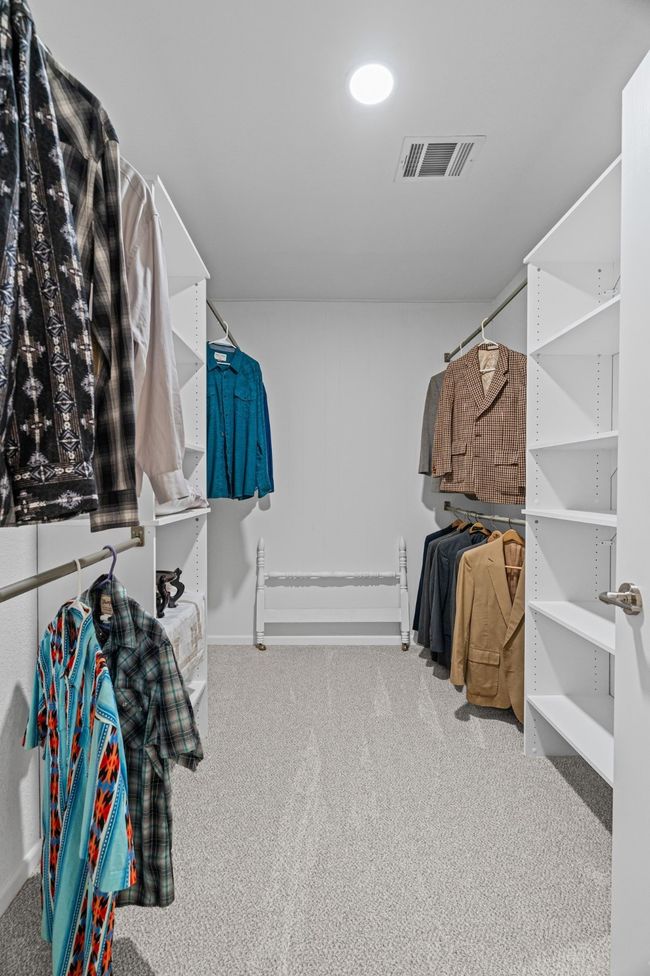 Spacious closet with carpet flooring | Image 17