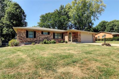 Ranch-style house with a garage and a front lawn | Image 3