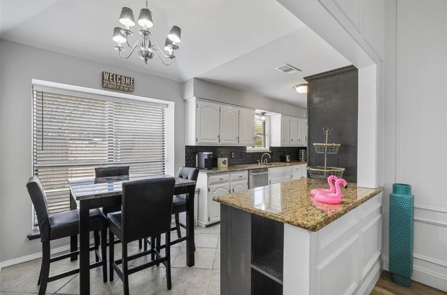 Kitchen nook with Vaulted ceiling and chandelier | Image 8