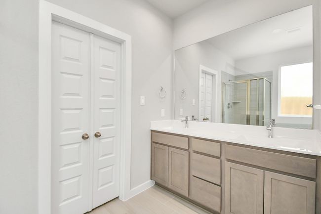 The primary bathroom is located alongside a spacious walk-in closet with shelving, high ceilings, custom paint, and sleek, dark modern finishes. An ideal retreat for unwinding after a long day! | Image 26