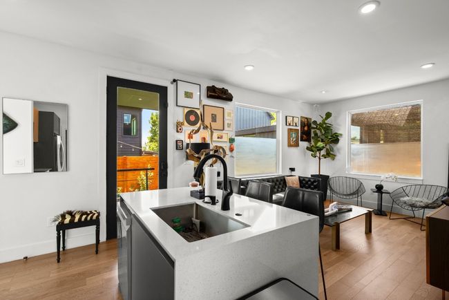 Kitchen with light wood finished floors, dishwasher, recessed lighting, and light countertops | Image 13