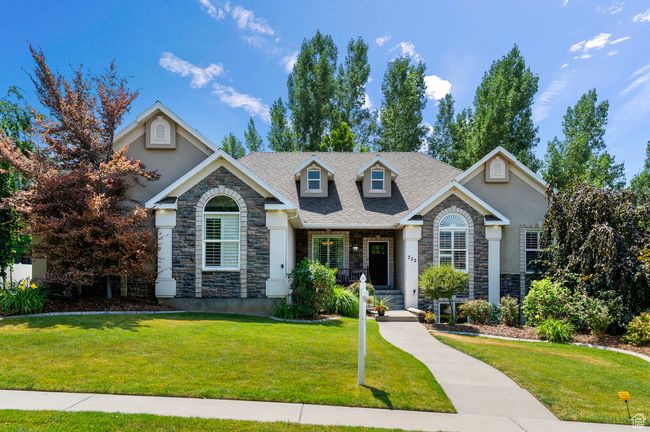 View of front of house with stone siding, a front lawn, and stucco siding | Image 5